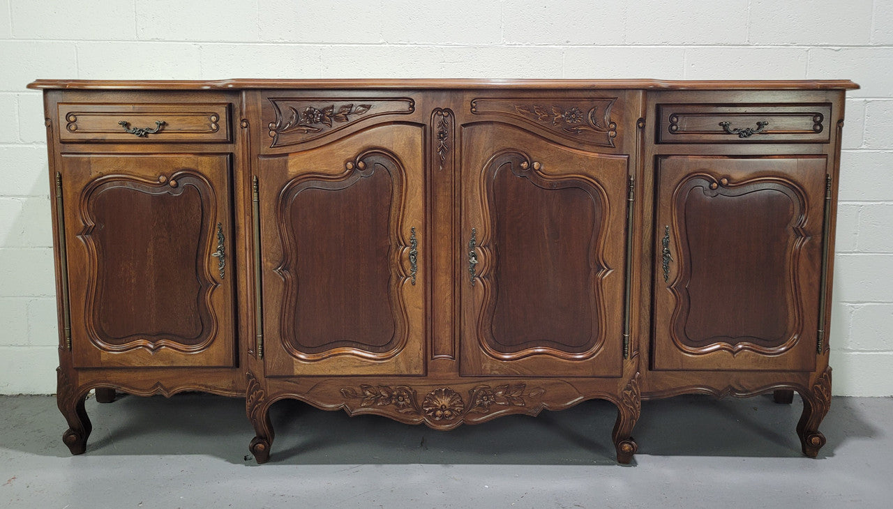 Walnut Louis XV style parquetry top four door sideboard with beautiful carving. Plenty of storage space and it is in good original detailed condition.