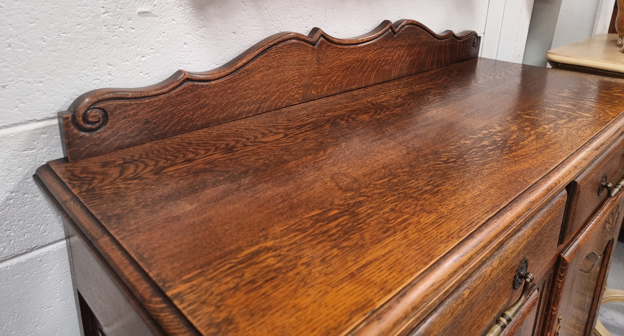 French Louis XV style Oak two door, two drawer sideboard. It is of pleasing narrow proportions and has one interior shelf. It has been sourced from France and it is in good original detailed condition.