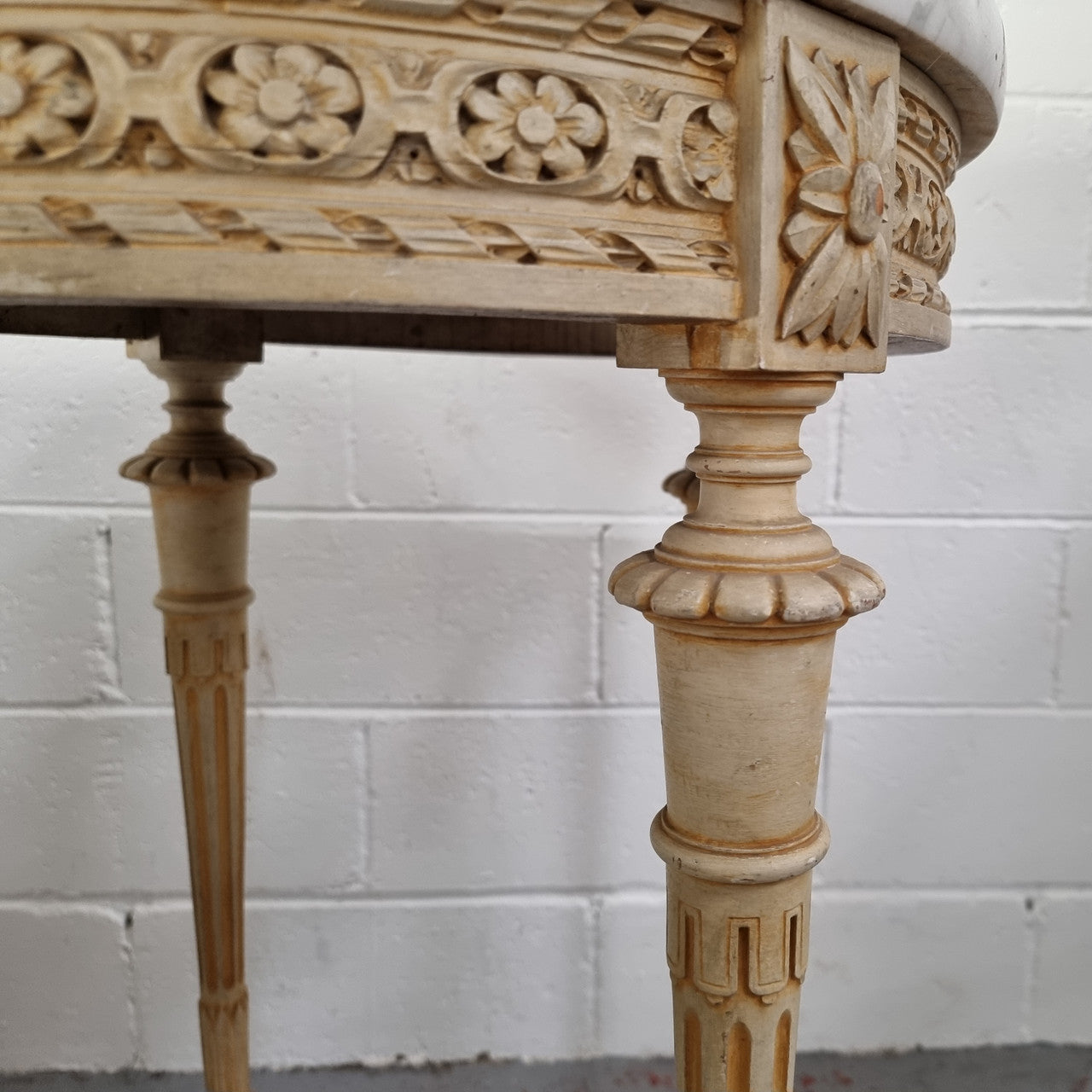 Louis XVI style round side table with original paint and a beautiful thick marble top. It is in good original detailed condition.