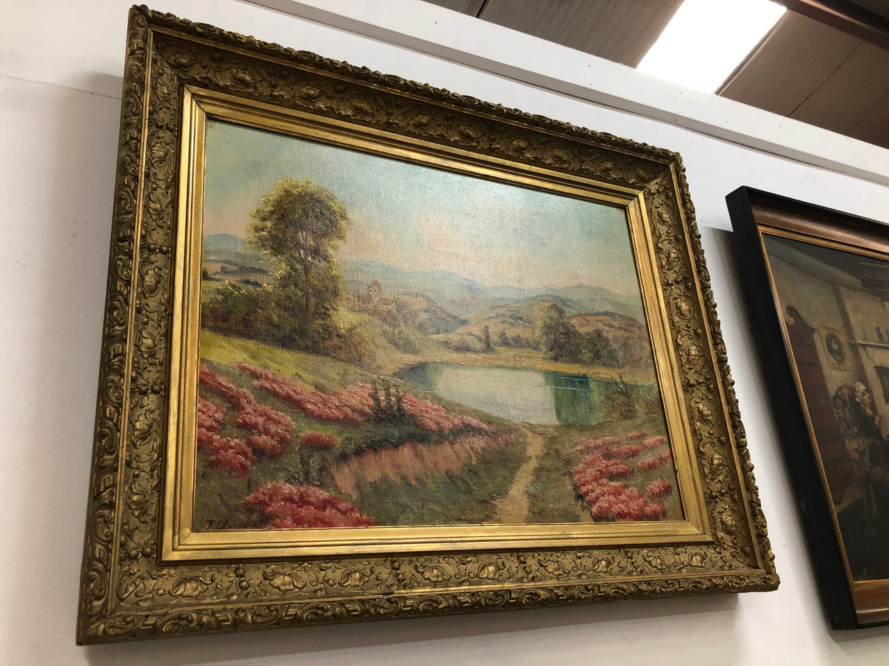 Beautiful French country scene oil on canvas in a lovely decorative frame in good original condition..