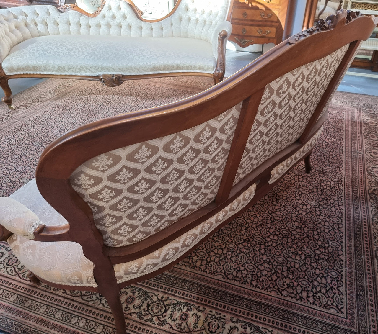 A late 19th Century French Walnut Louis XV style settee with a serpentine front. This settee upholstery is like new and is in very good condition.