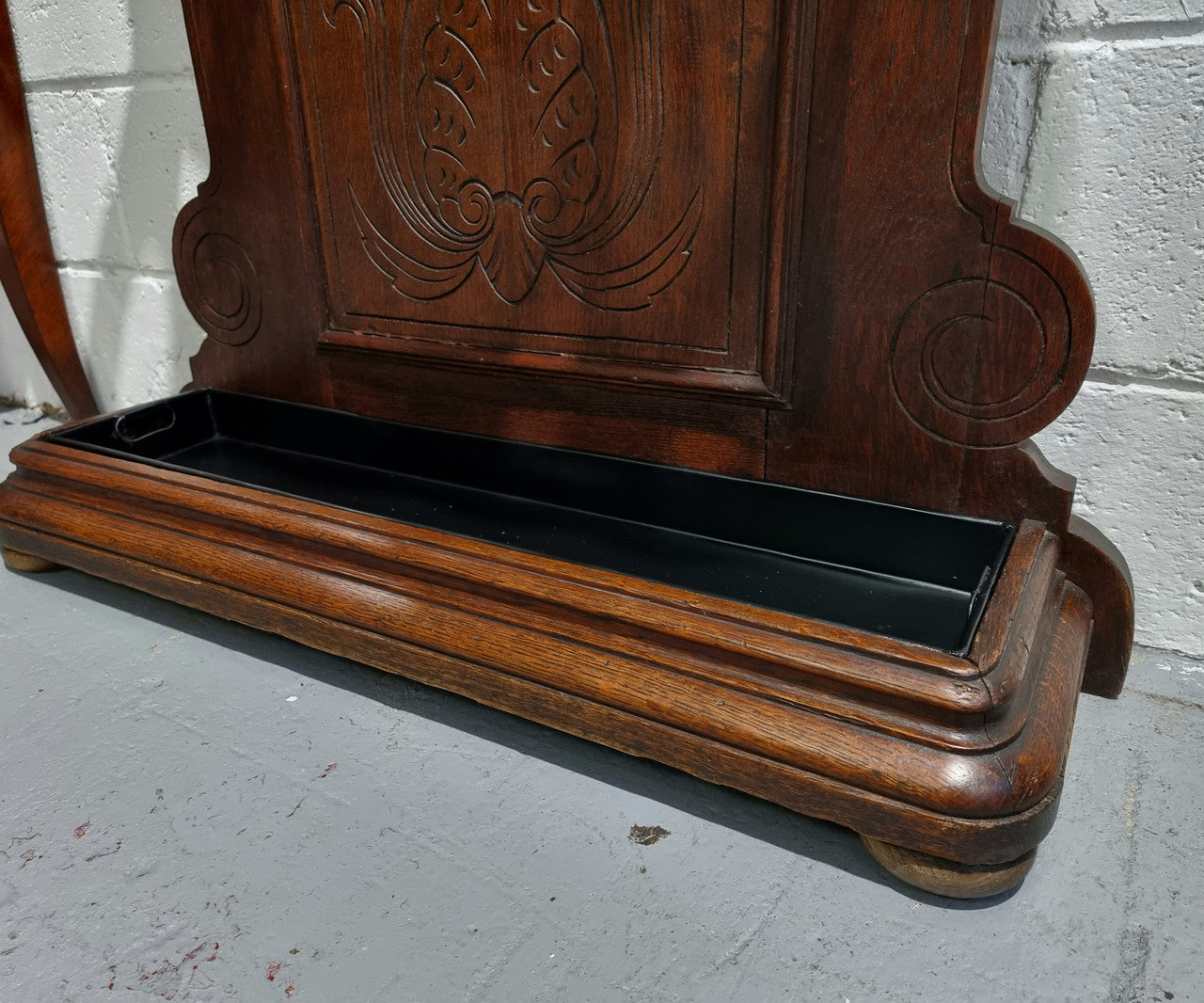 A beautiful Henry II style narrow French Oak hall stand. It has beautiful decorative carvings as well as 8 wooden hooks and storage for umbrellas and walking sticks. In good original detailed condition.