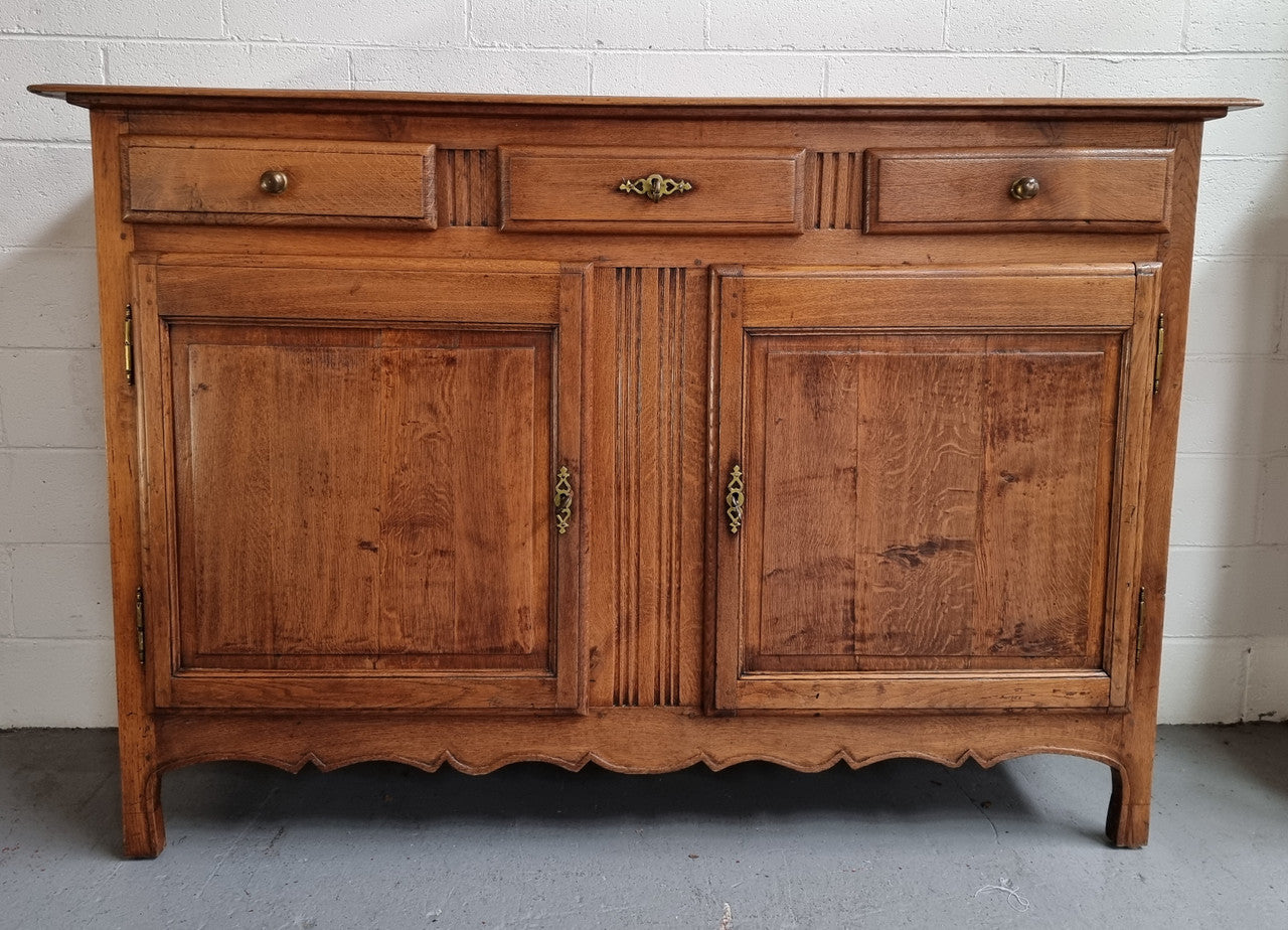 French Oak Early 19th Century sideboard with two doors and three drawers. In good original condition.