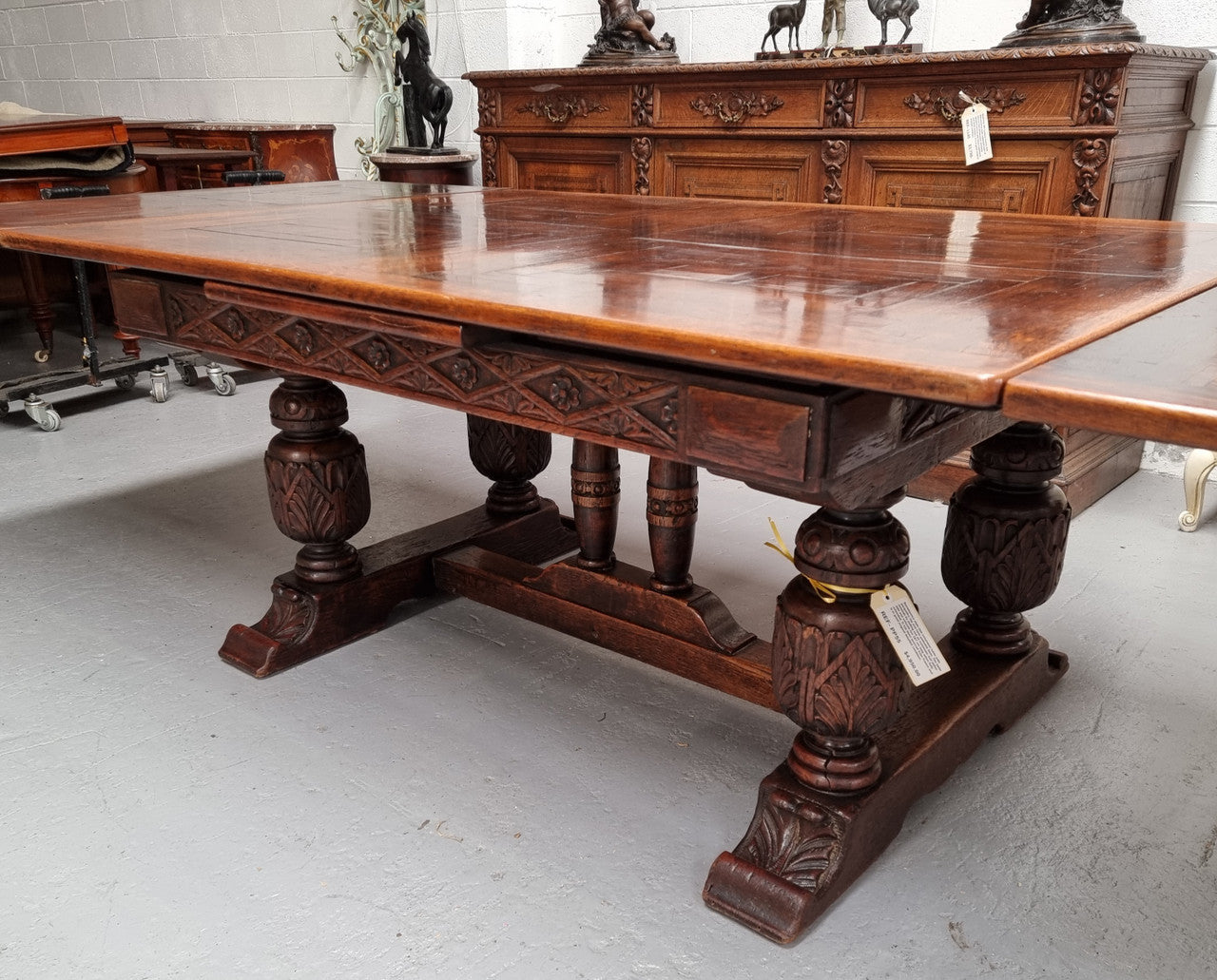 Renaissance style Oak extension table with parquetry top and twin pedestal base. The table extends by pulling out an extension leaf either side making it 287 cm long. Sourced from France and in good original detailed condition.