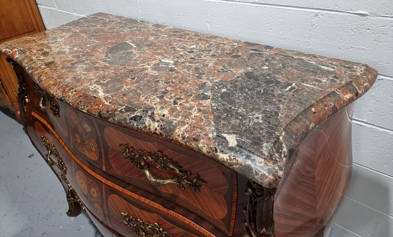 French Walnut and Kingwood Louis XV style marquetry inlaid commode with three drawers and a beautiful marble top. It is in good original detailed condition.