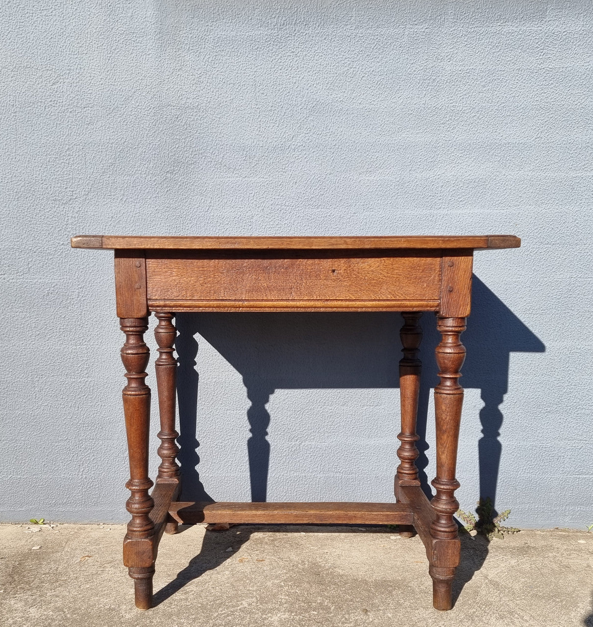 Lovely Oak Tudor style rope edge sideboard with leadlight centre door, three drawers and two solid cupboards. In good original condition.