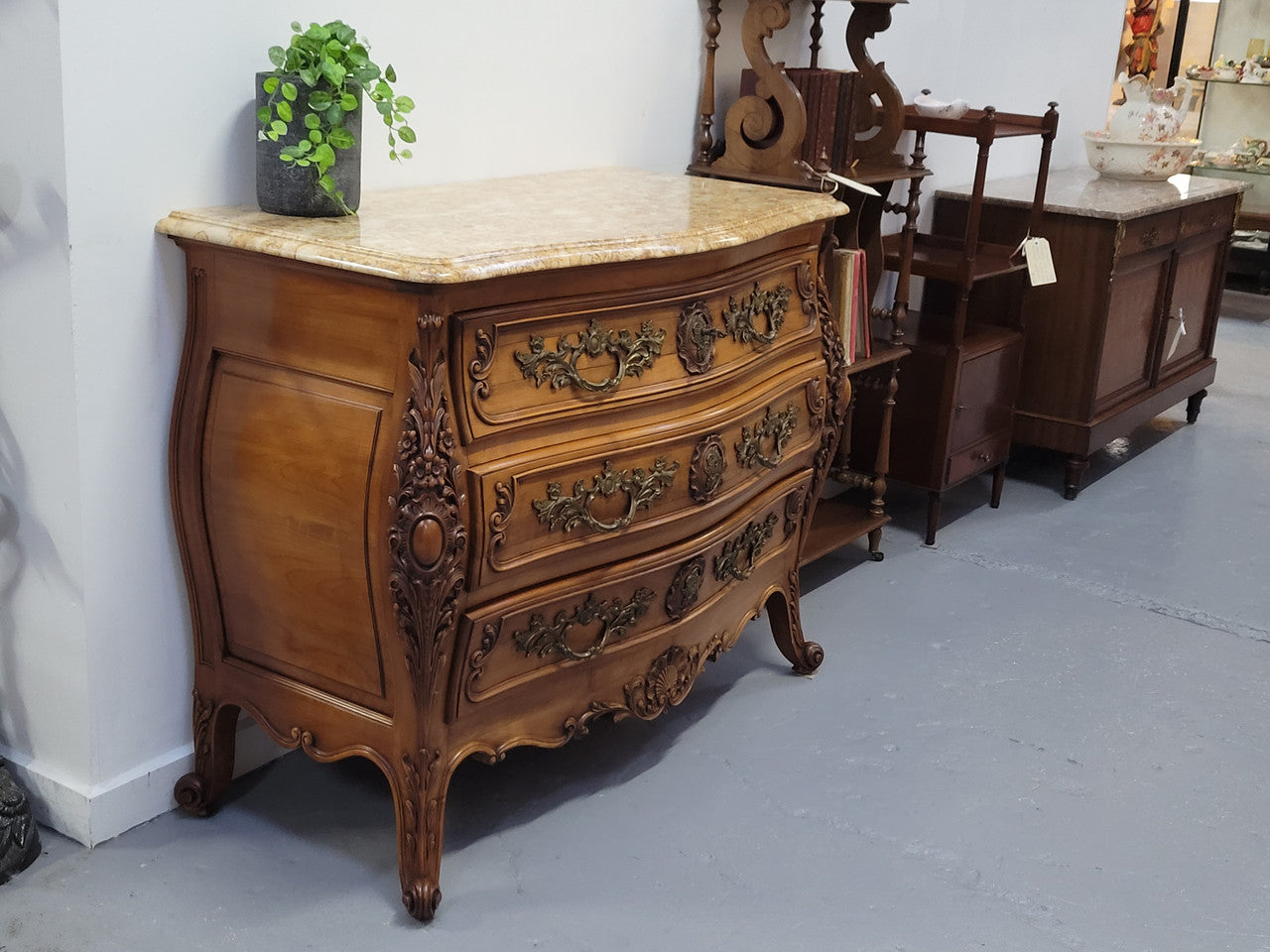 Impressive Louis XV style three drawer walnut commode. Ormolu handles and bevelled marble top complimenting detailed carving. In very good original detailed condition.
