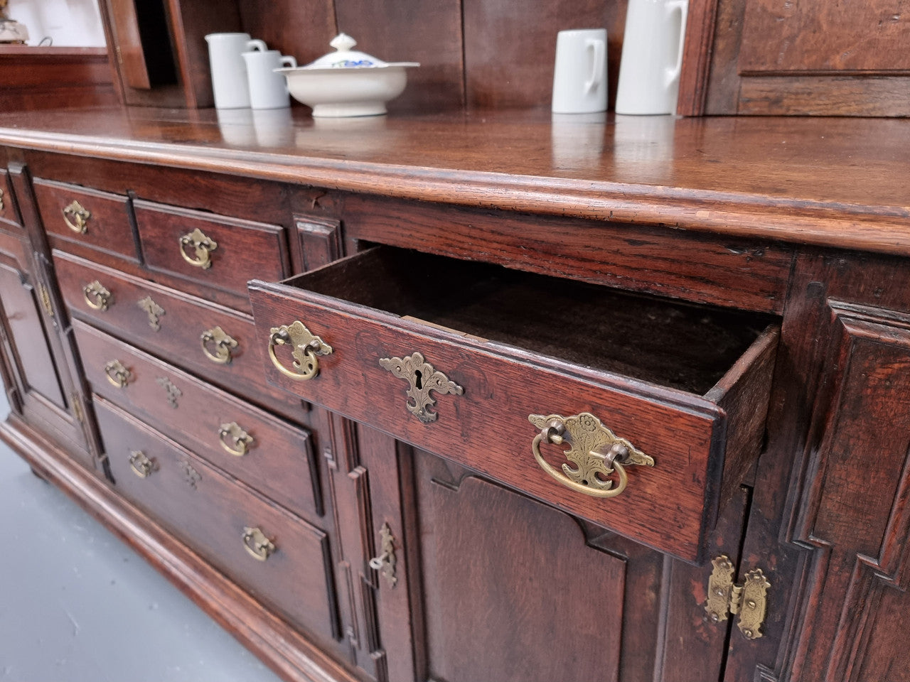 18th Century English Oak Farmhouse dresser of grand proportions. It was sourced in France and not only looks amazing but also has plenty of practical storage space. It is in good original detailed condition.