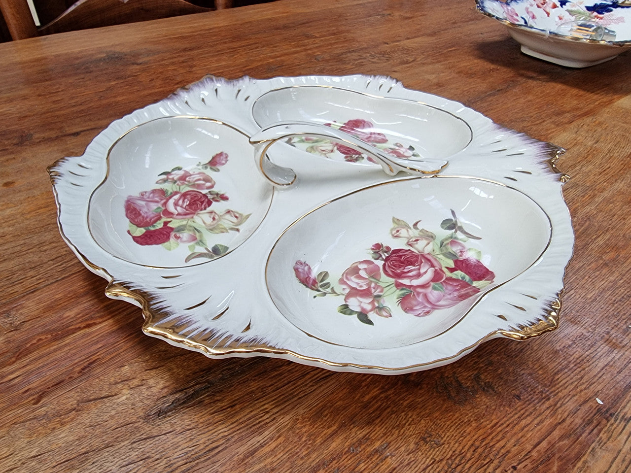 Vintage ceramic three sectional floral bowl with handle and gilt rim. Stamped underneath and in good original condition with no chips or cracks. Please view photos as they help form part of the description.
