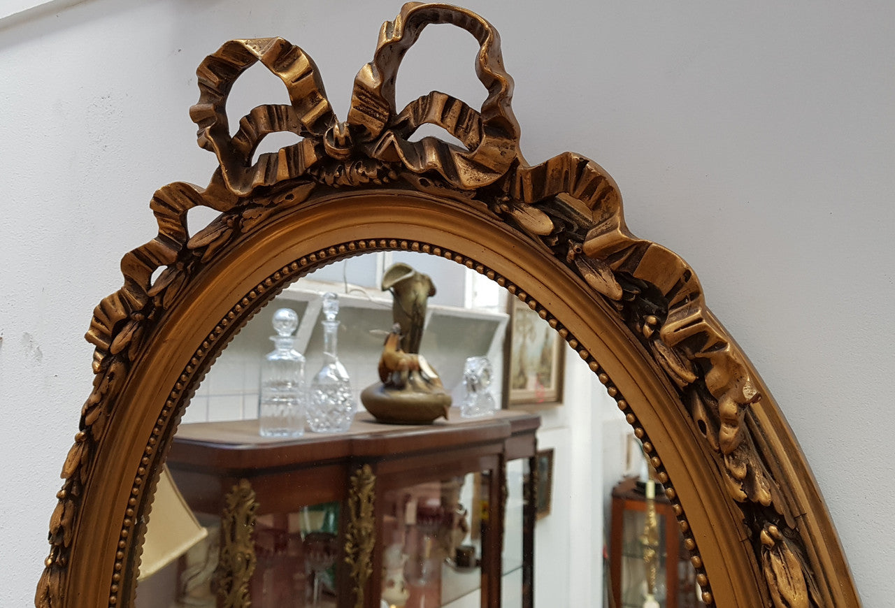 Antique French Gilt Oval Shape Mirror With Ribbon Crest