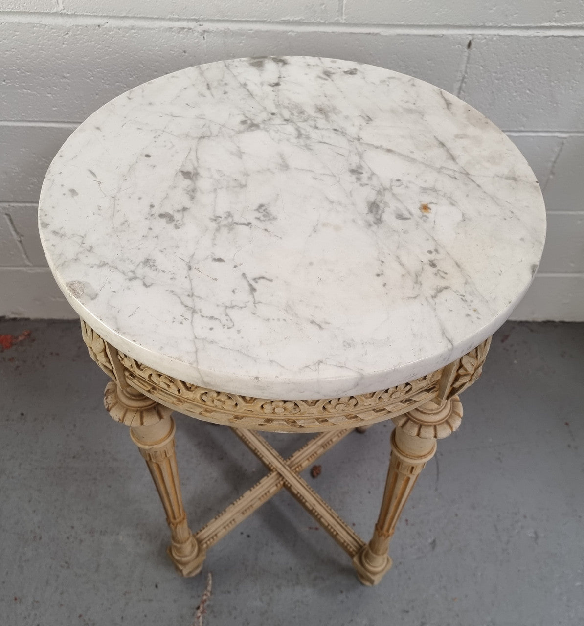 Louis XVI style round side table with original paint and a beautiful thick marble top. It is in good original detailed condition.