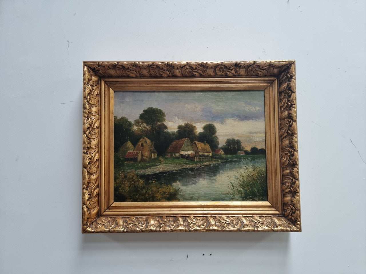 Lovely framed original oil on canvas of a country cottage scene on a river in good original condition