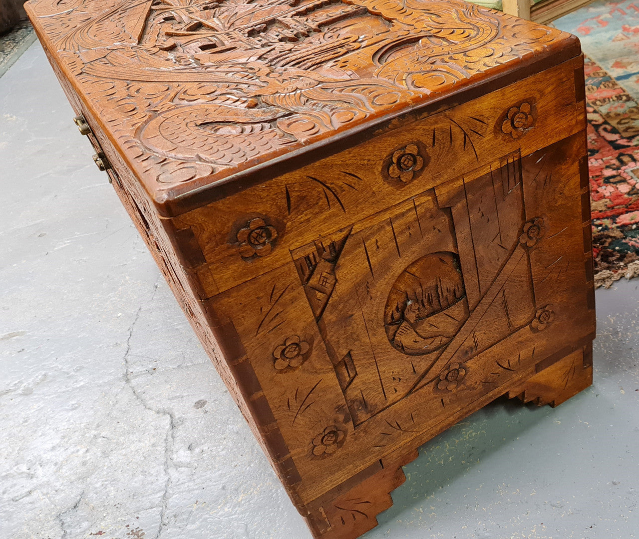Vintage nicely carved Camphor wood chest. It has amazing carvings of boats, dragons and temples. It is in good original detailed condition.