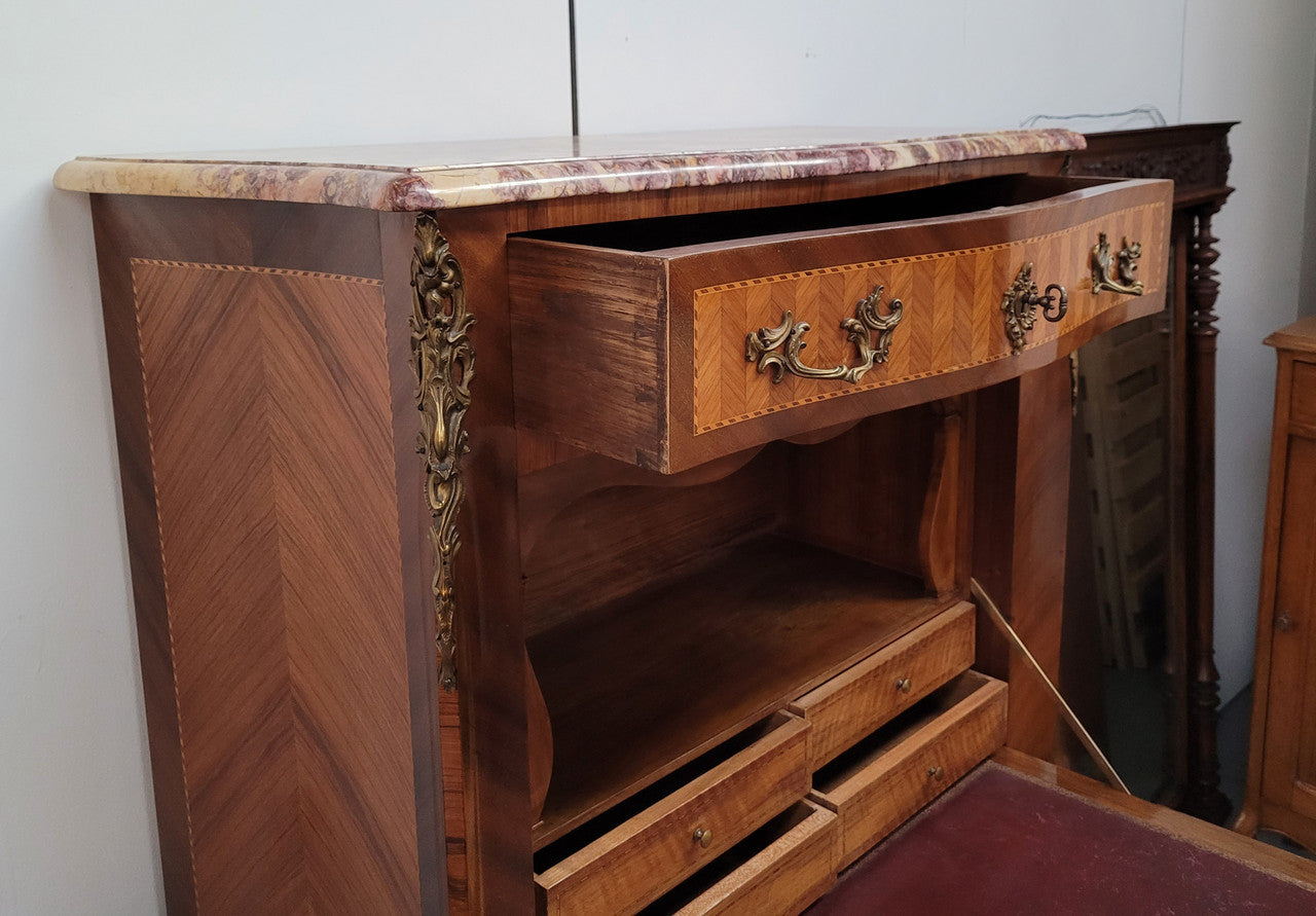 Walnut Louis XV style marble top abbattant with beautiful parquetry inlay and ormolu mounts. It has plenty of storage space with four large drawers and four smaller internal drawers. Beautiful drop down desk with a leather insert. In very good original detailed condition.
