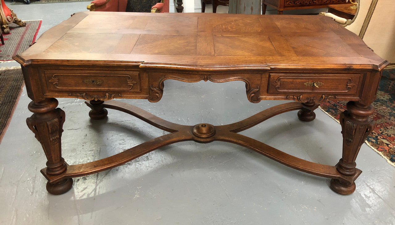 Beautifully carved 19th century French oak Bureau Plat. With a lovely parquetry top and two drawers and decorative carved legs this piece is definitely one to look at . In good original detailed condition.