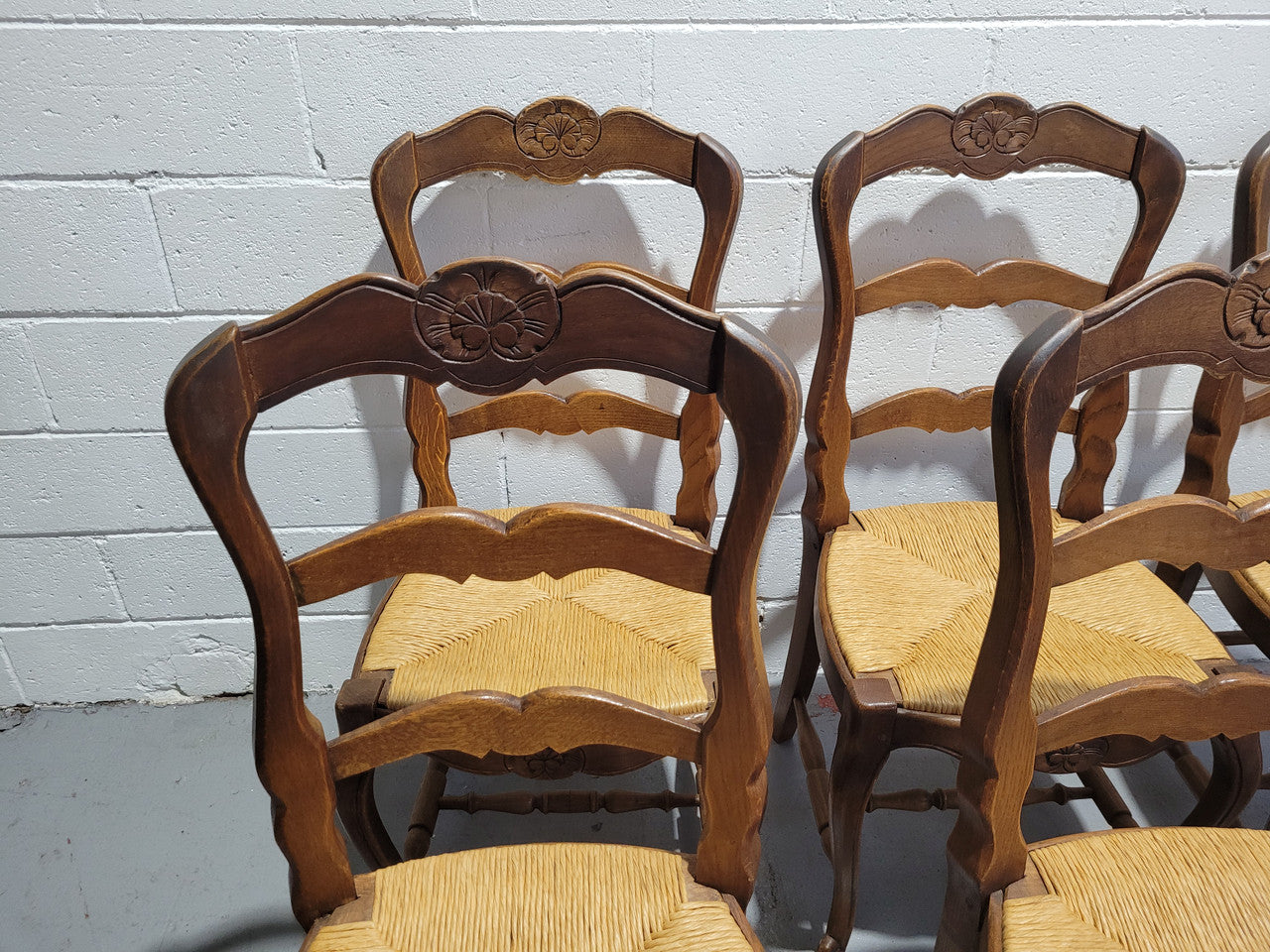 A stunning set of six French Louis XV Style oak dining chairs with rush seats in good original condition. All chairs have been detailed and re-glued where needed.