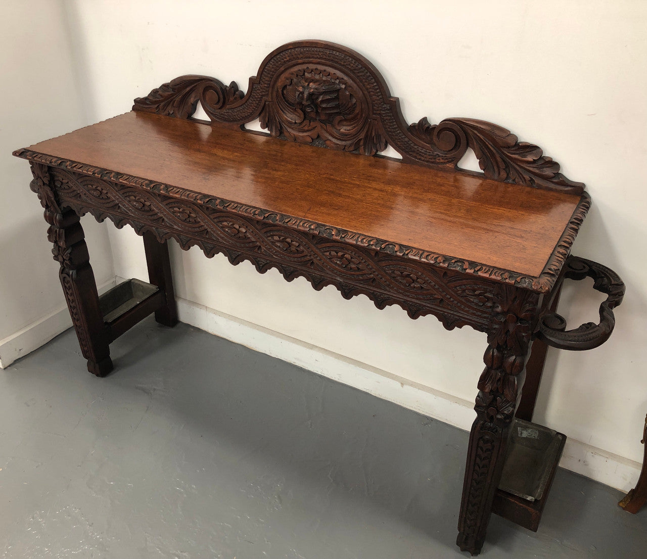 Superb 19th Century Gothic style hall/console table. It has umbrella and walking stick holders on both sides. In good original detailed condition.