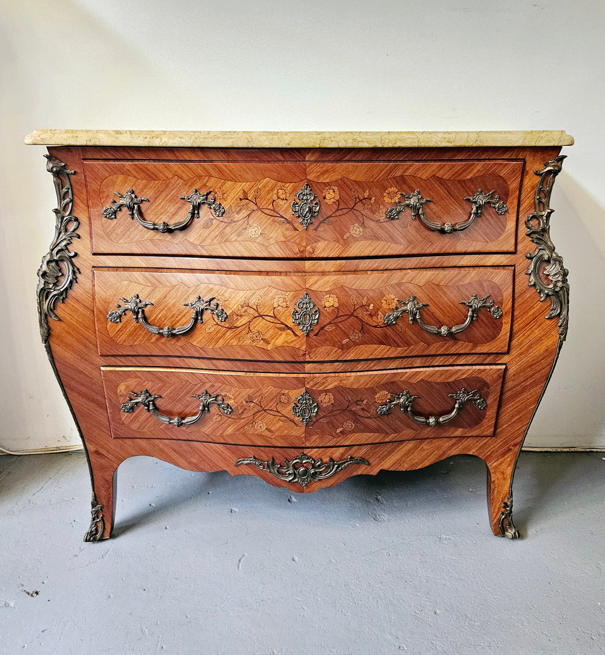 Stunning French Louis 15th style marble topped three drawer commode with marquetry inlay and stunning ormolu mounts. In good original detailed condition.