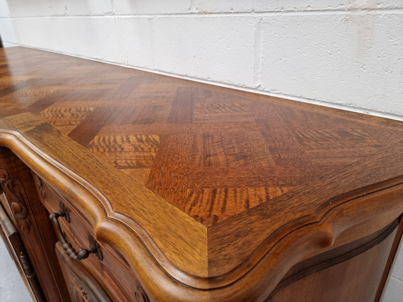A Beautifully carved French Walnut Louis XV style four door sideboard. Plenty of storage space with four doors as well as four drawers. It is in good original detailed condition.