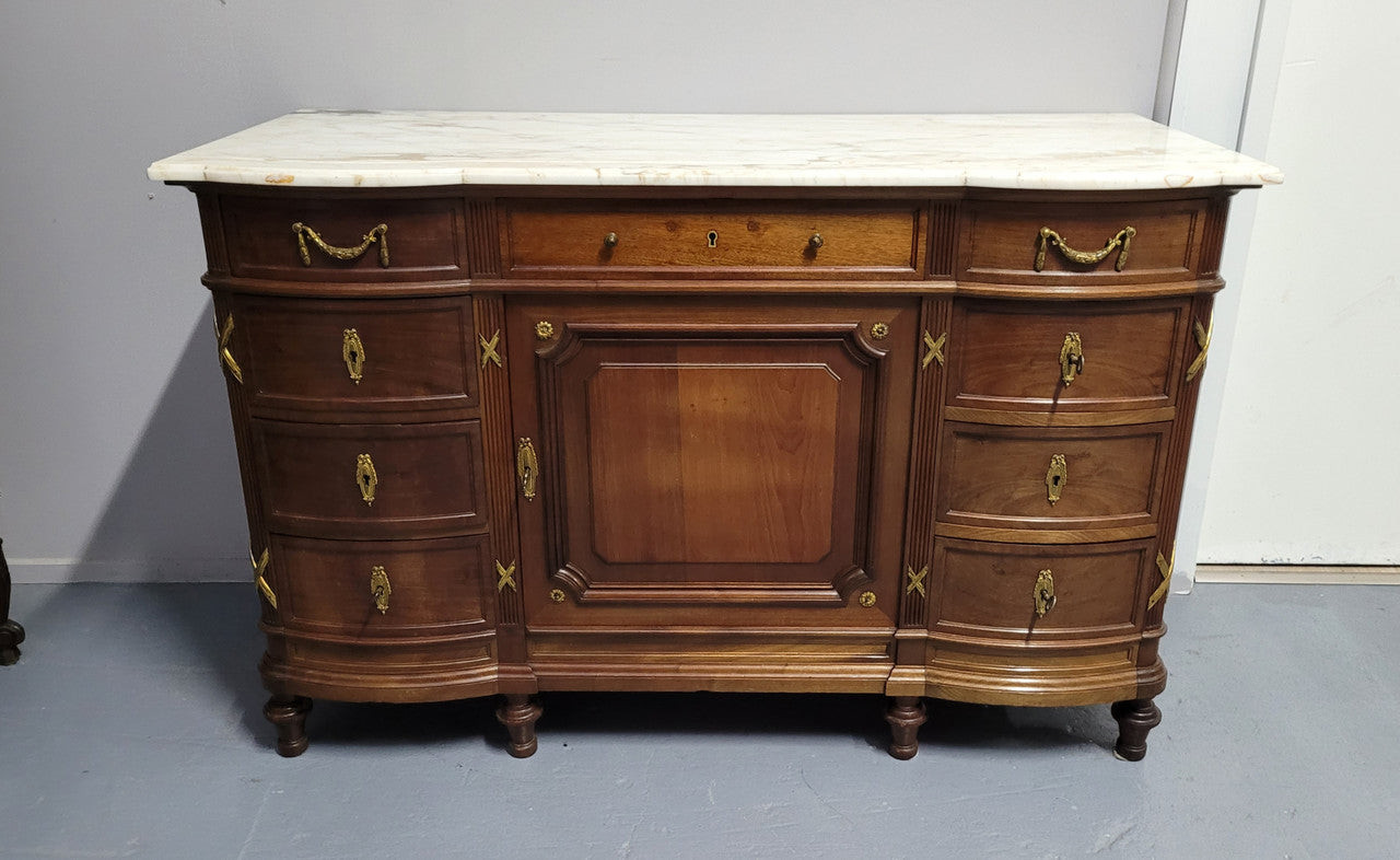 Fabulous French Walnut Louis XVI style cupboard, with a lovely marble top and nine drawers. There is also a cupboard and beautiful ormolu mounts. It is in good original detailed condition.