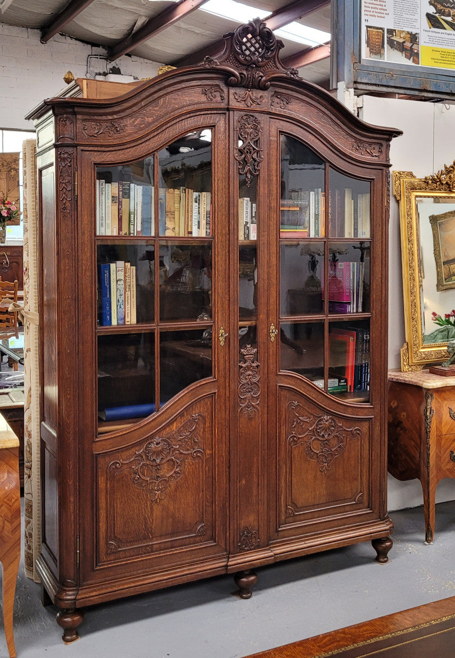Substantial French Oak Louis 15th Style large two door bookcase. Adjustable shelves and very decorative carving. In good original detailed condition.
