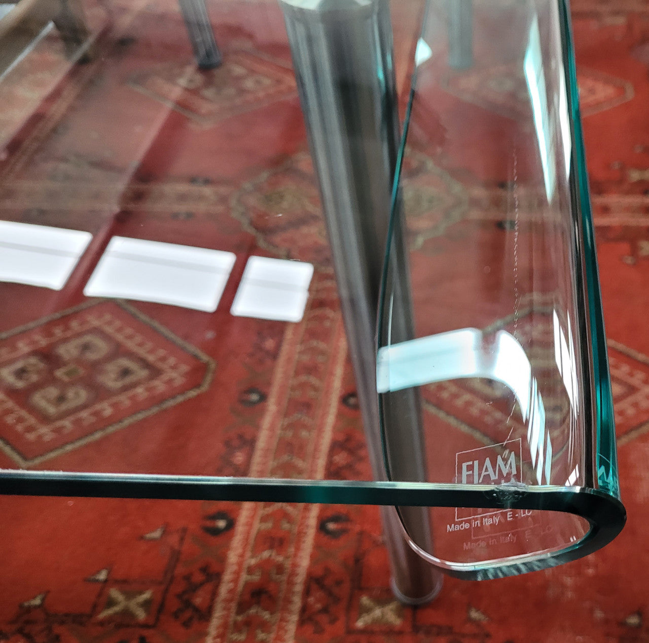 Striking and distinctive Vintage FIAM Italia Designer curved edge glass desk. FIAM was founded in 1973 by Vittorio Livio and has become synonymous with glass culture in Italy and the World. FIAM is still manufacturing today, in collaboration with various Designers, and has won numerous awards and is represented in various international museums. 
Condition: Evidence of use with minor scratches to the surface and a small chip that has been repaired. Overall, in very good condition with one repaired chip to t