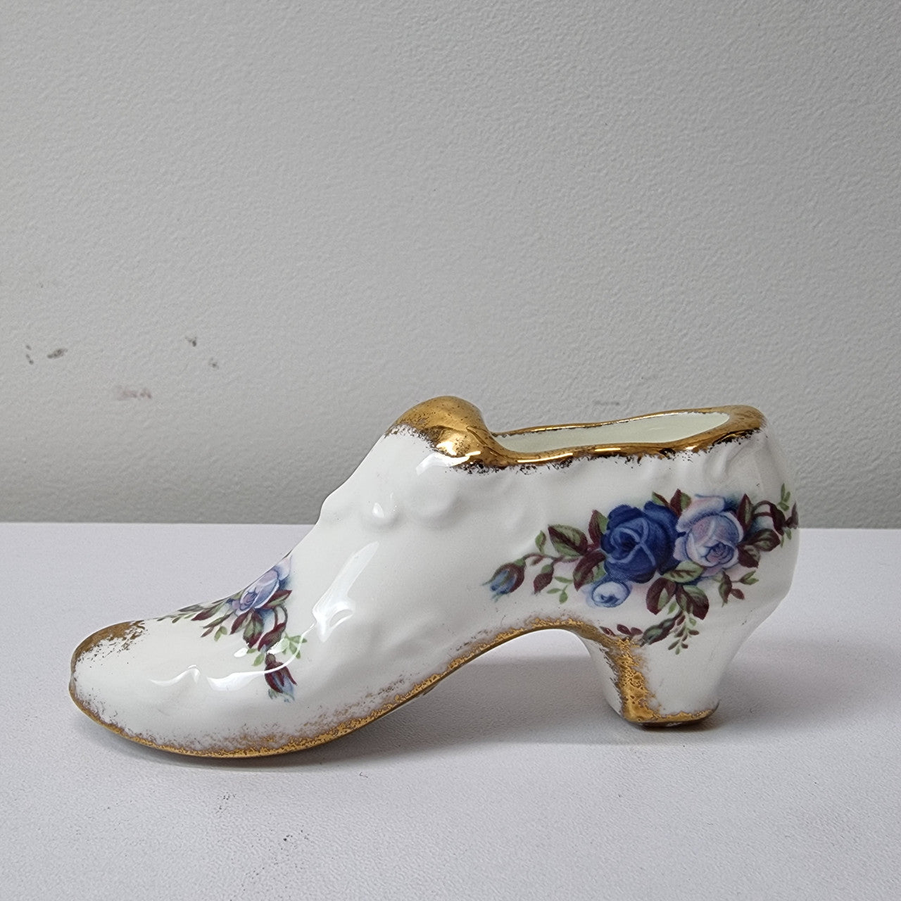 A lovely pair of Royal Albert China shoes in good original condition. Stamped on the sole 'Moonlight Rose: Royal Albert Bone China, England ©1987.