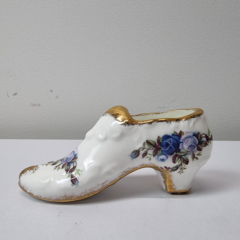 A lovely pair of Royal Albert China shoes in good original condition. Stamped on the sole 'Moonlight Rose: Royal Albert Bone China, England ©1987.