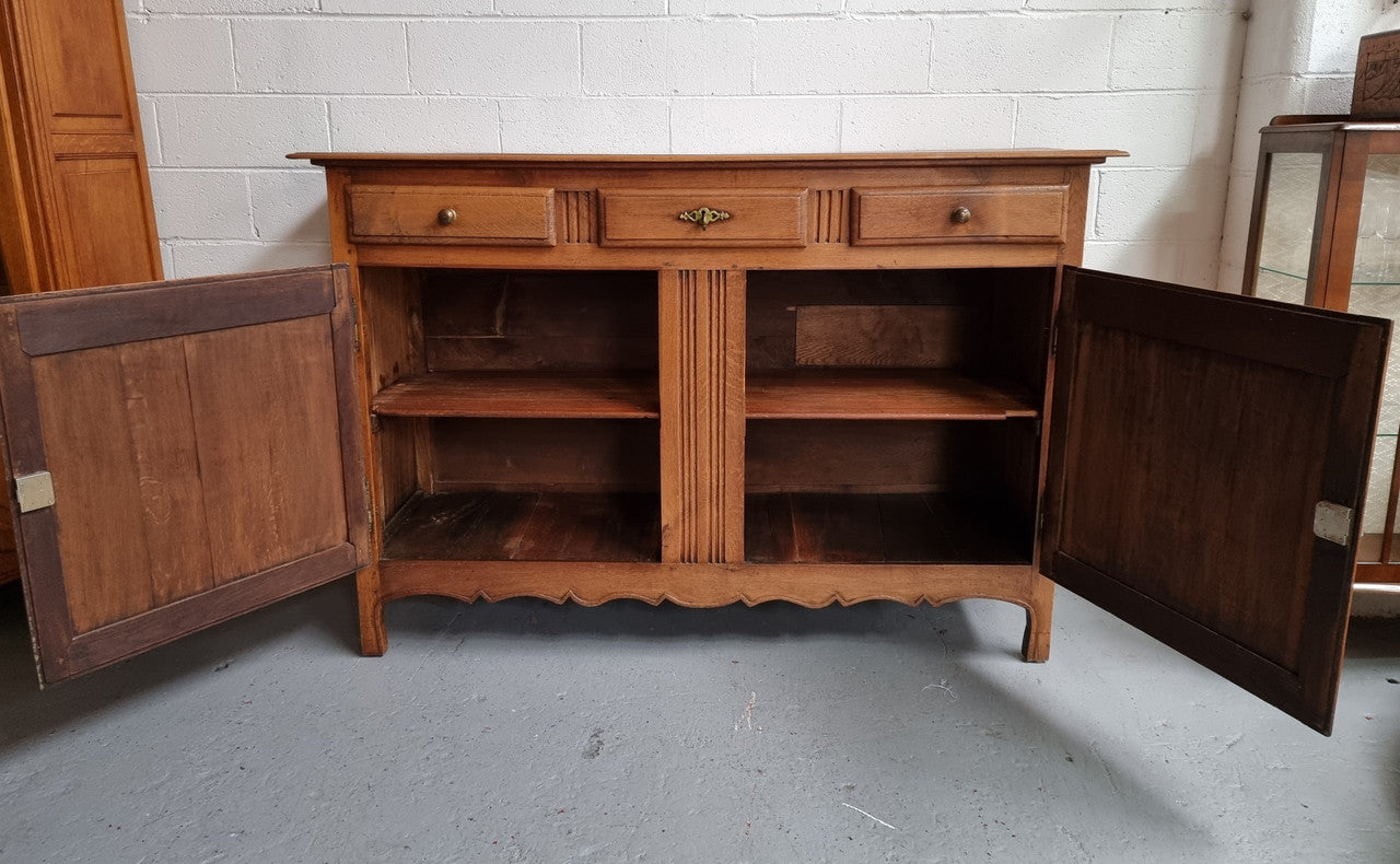 French Oak Early 19th Century sideboard with two doors and three drawers. In good original condition.