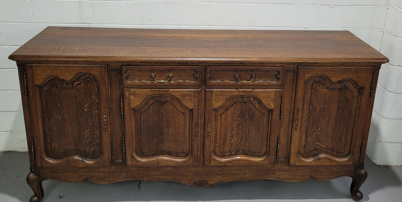 Late 19th Century French carved Oak Louis XV style four drawer sideboard. Plenty of storage space with four cupboards and two drawers. It is in good original detailed condition with all locks functioning with keys.