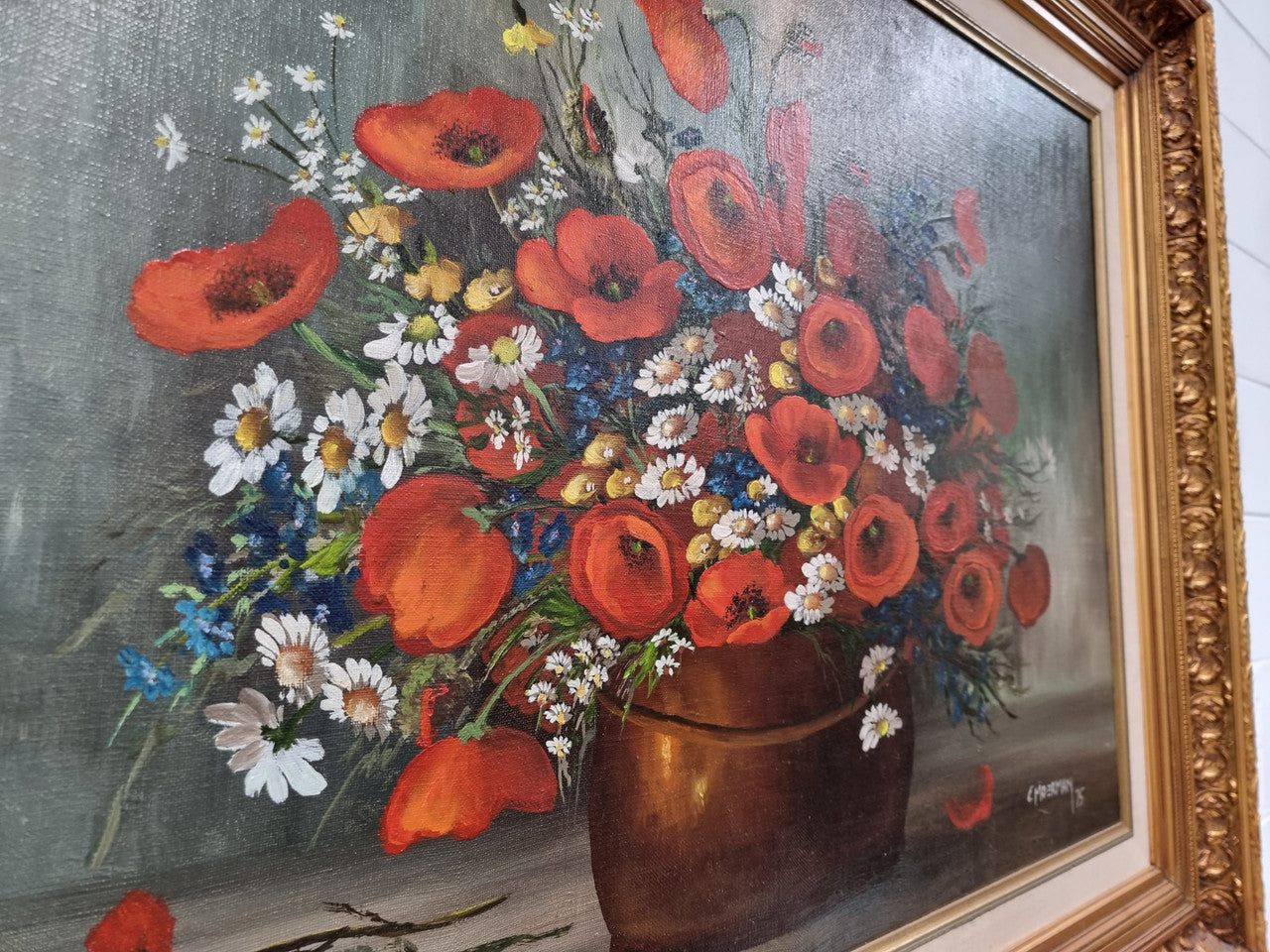 Lovely Vintage signed floral oil on canvas of Poppies and Daisy's and in a decorative gilt frame . In good original detailed condition.
