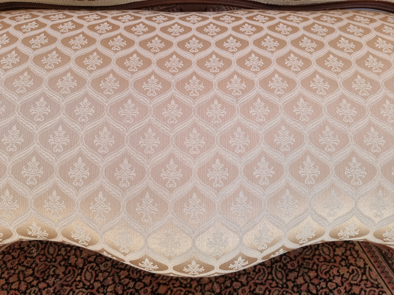 A late 19th Century French Walnut Louis XV style settee with a serpentine front. This settee upholstery is like new and is in very good condition.