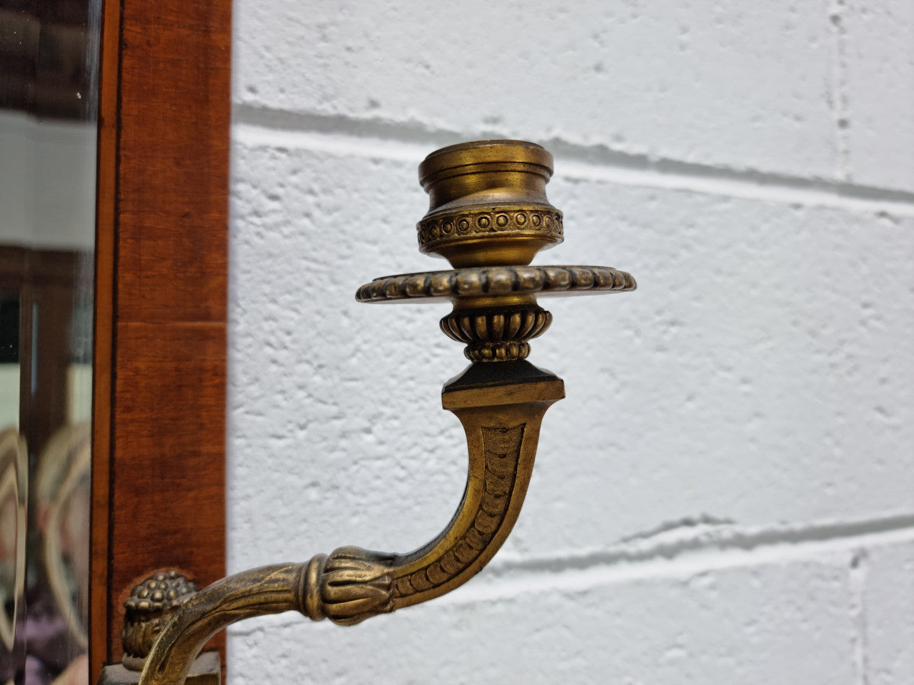 Decorative late 19th Century mahogany French wall mirror with brass swivel candle holders and brass detail. In good original detailed condition.