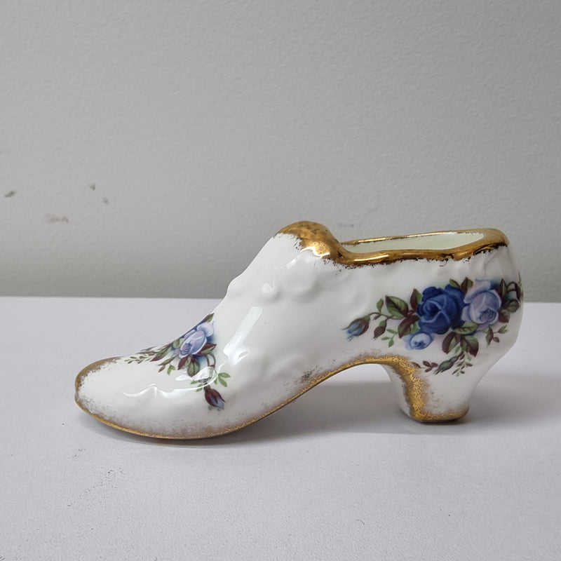 A lovely pair of Royal Albert China shoes in good original condition. Stamped on the sole 'Moonlight Rose: Royal Albert Bone China, England ©1987.