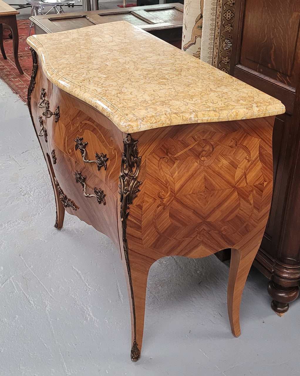 An elegant French Louis XV style kingwood two drawer commode with beautiful decorative inlay and ormolu mounts. Stunning coloured marble top and is in good original detailed condition.