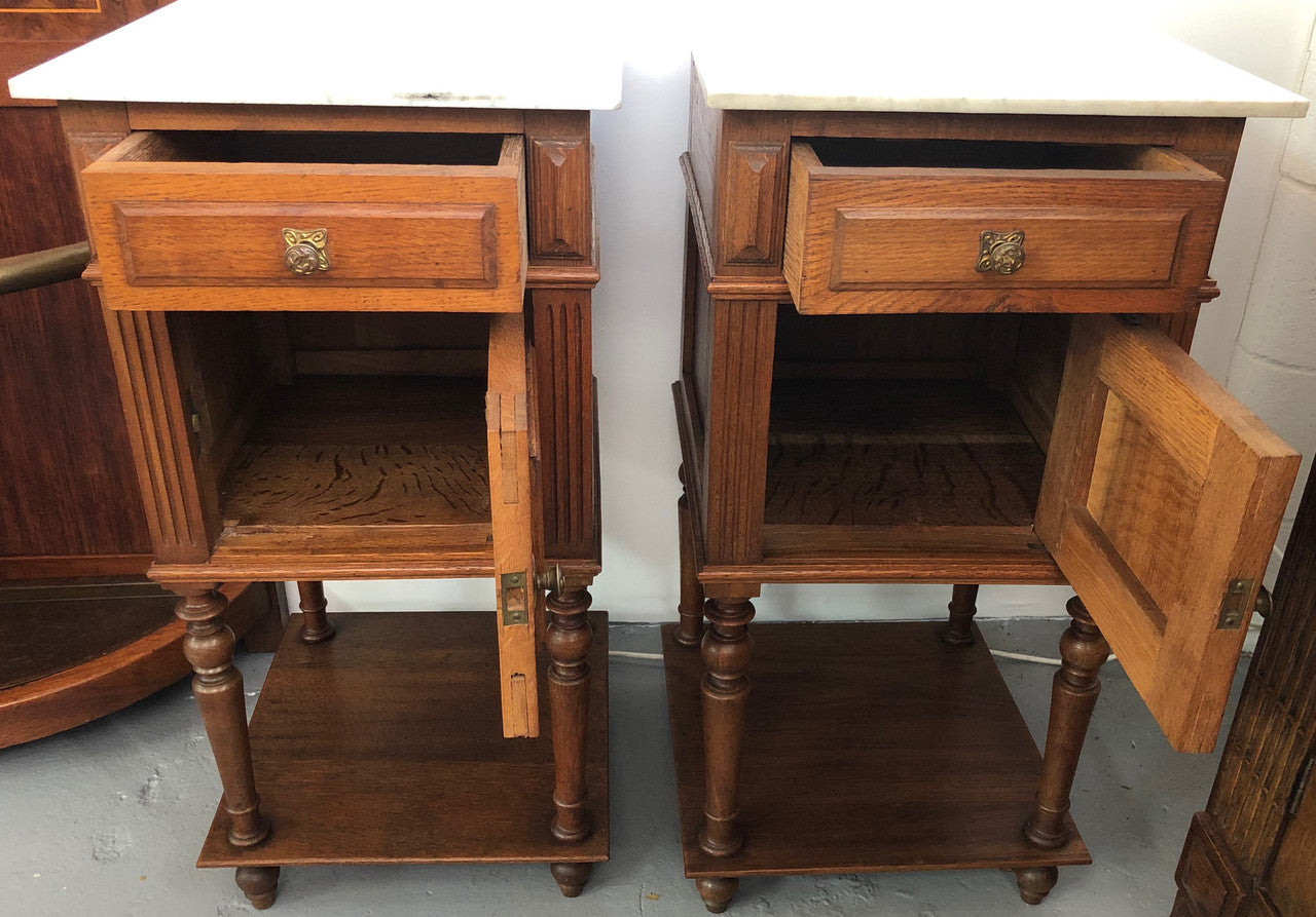 A lovely pair of French Oak, marble top bedside cabinets with a cupboard and drawer in good original condition.