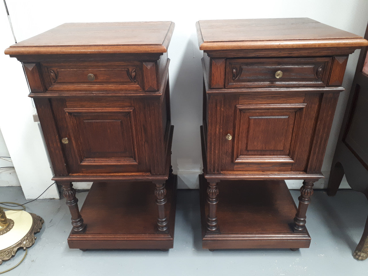A hard to find pair of French Oak wooden top bedside cabinets. In good original condition. Circa 1920.