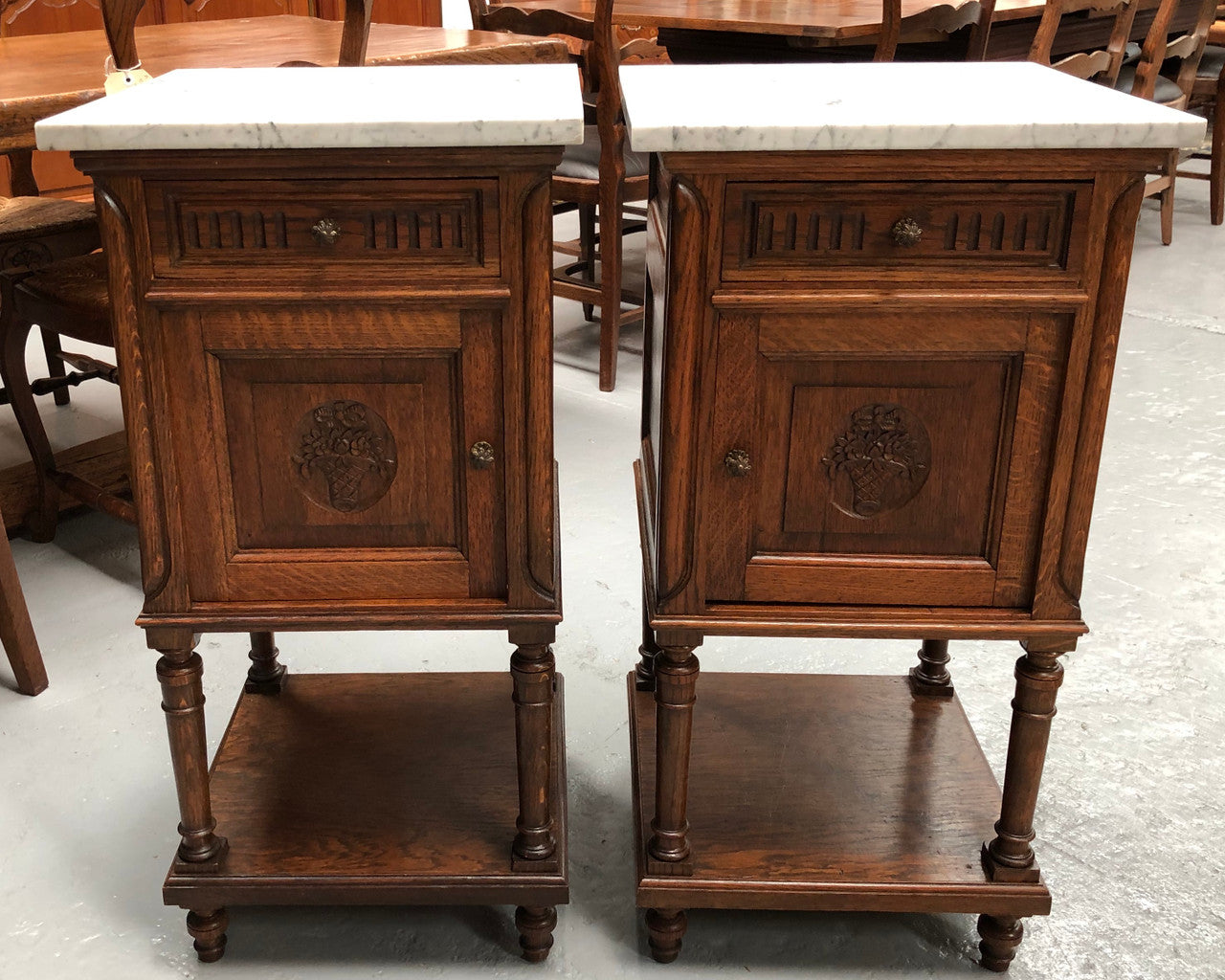 A french oak pair of carved bedside cabinets, with lovely detail and nice coloured marble tops and plenty of storage space. In good condition.
