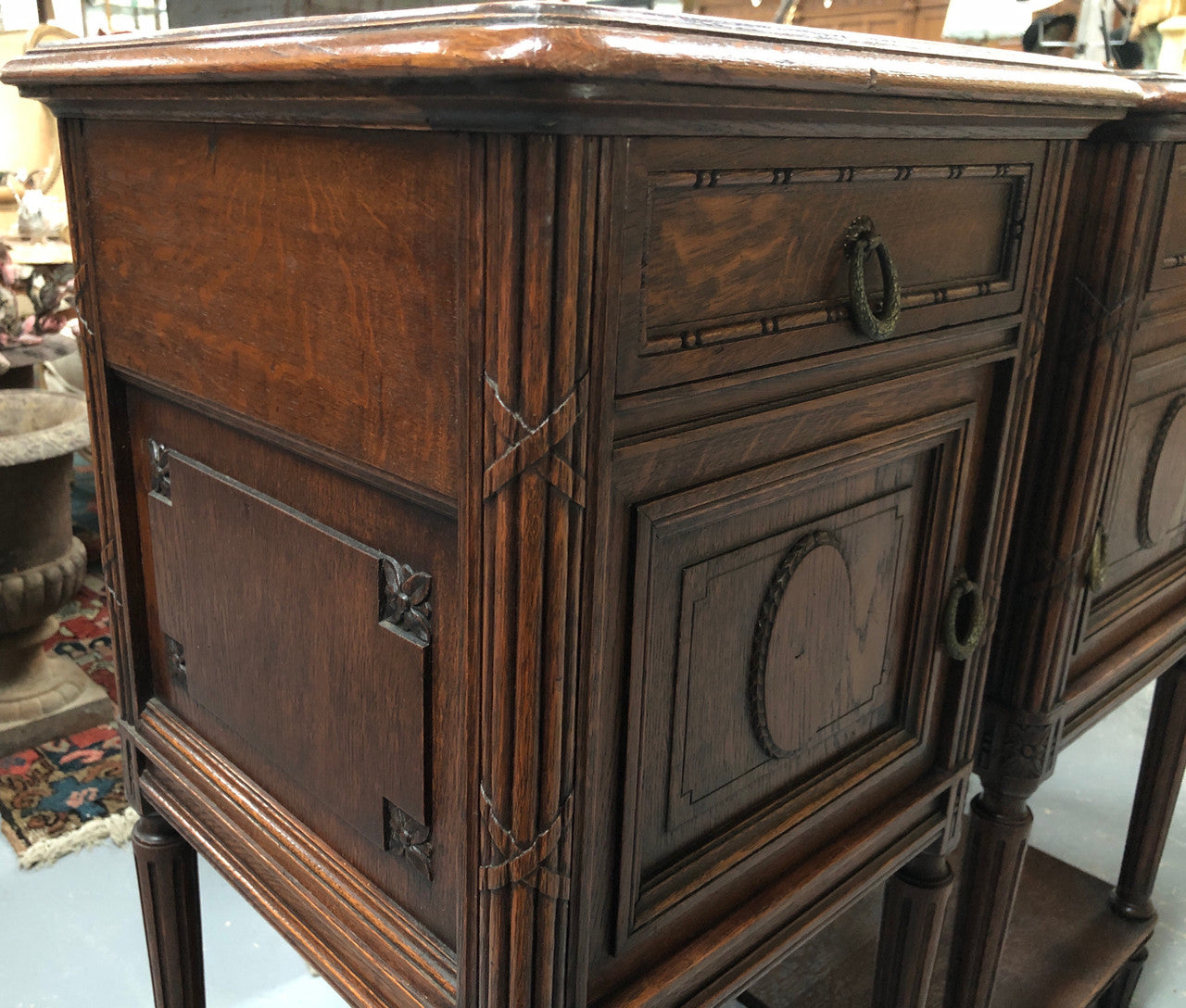 Lovely pair of French Oak Louis XVI style bedside cabinets with inset marble tops a drawer and a cupboard for storage. In good original detailed condition.