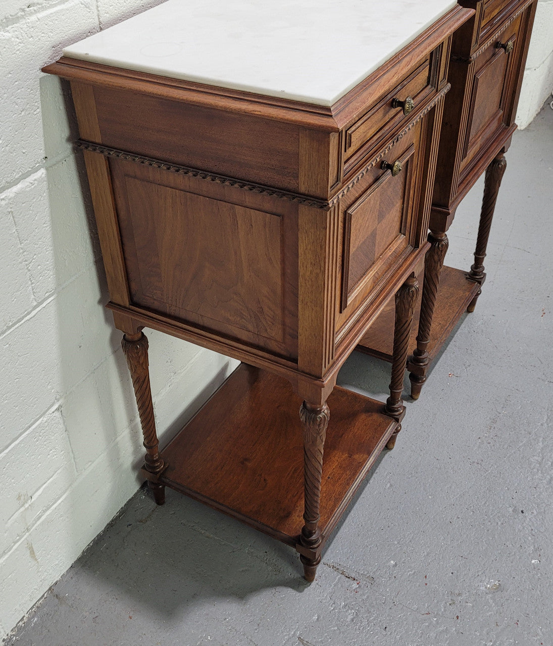 Pair parquetry Walnut bedside cabinets with white inset marble tops. In good original detailed condition.