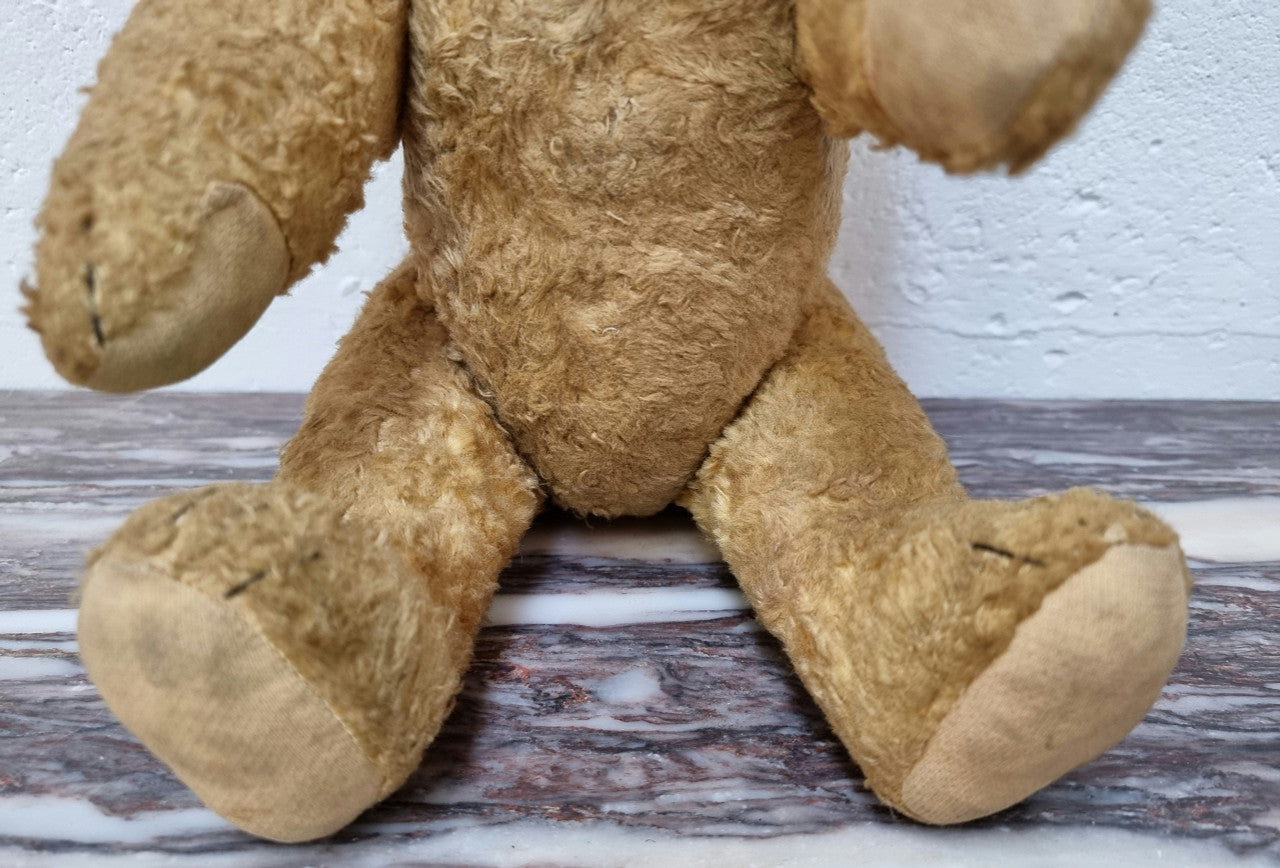 Part of a huge collection is this adorable old Vintage Teddy bear with glass eyes. The growler still works and he is in good original condition.