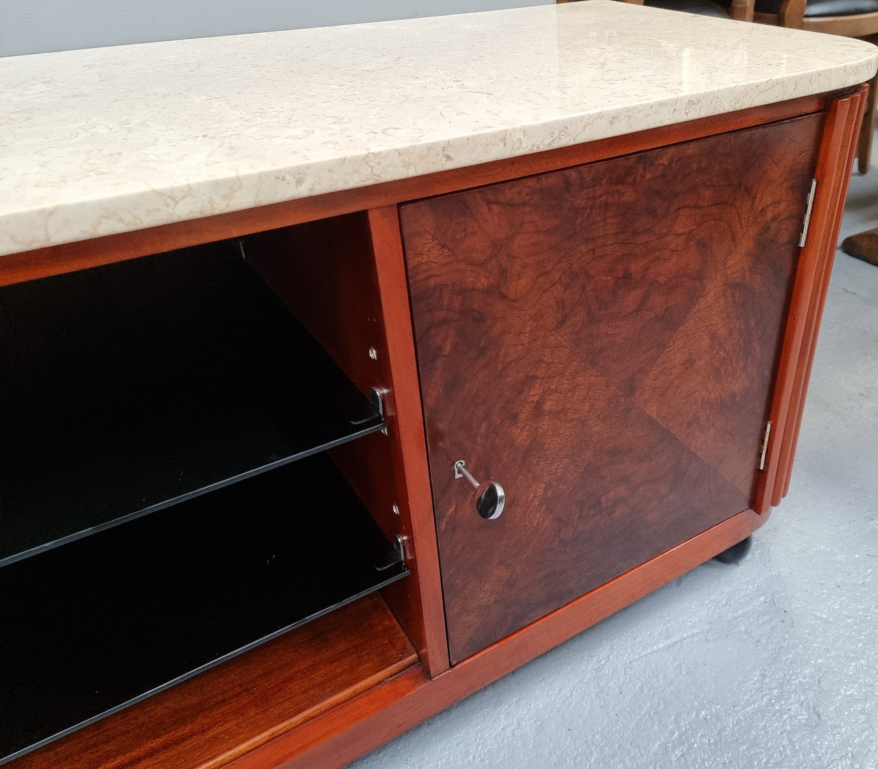 Beautiful Bespoke Art Deco style walnut and mahogany low line cabinet with a marble top and plenty of storage. It has two doors with a shelf each side and in the middle in has two glass shelves. Would make an ideal TV cabinet and has a hole in the back to run cords through. In very good original detailed condition.