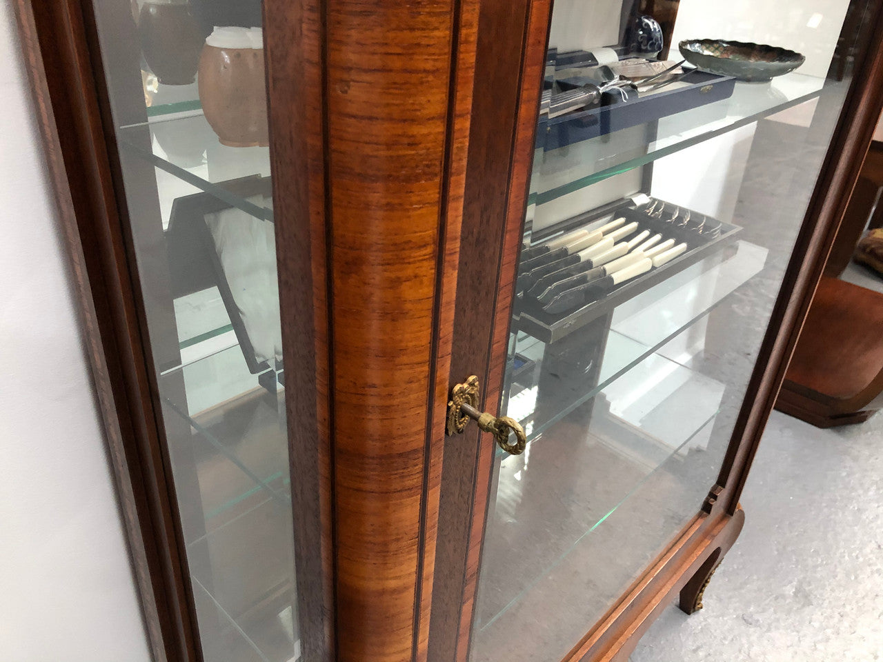 Beautiful French walnut and parquetry inlaid vitrine with lovely bevelled glass and a marble top. It comes with four glass shelves which are adjustable and it is in good original condition.