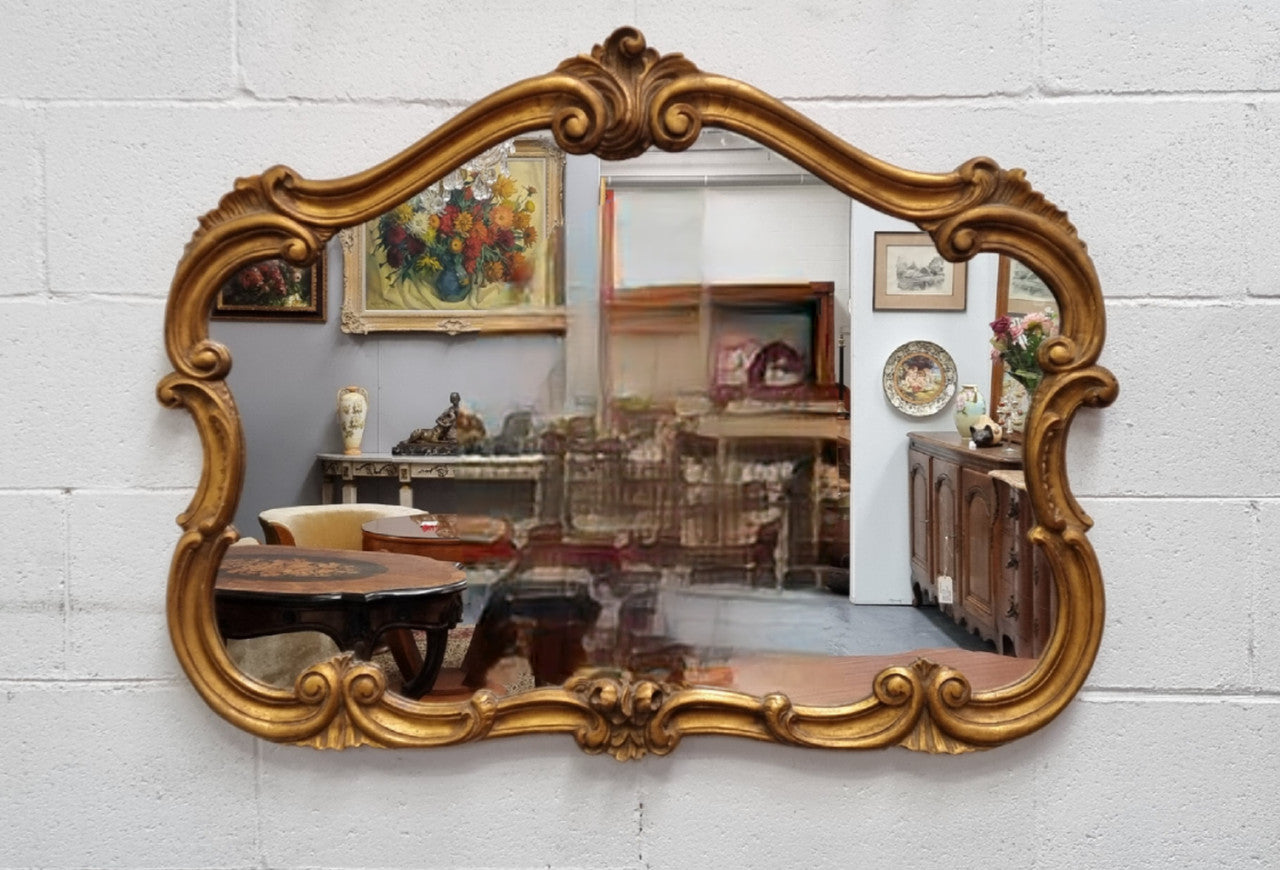 French Louis XV style wood carved and gilded mirror. Mirror is original and showing signs of age. It has been sourced from France and in good original condition.