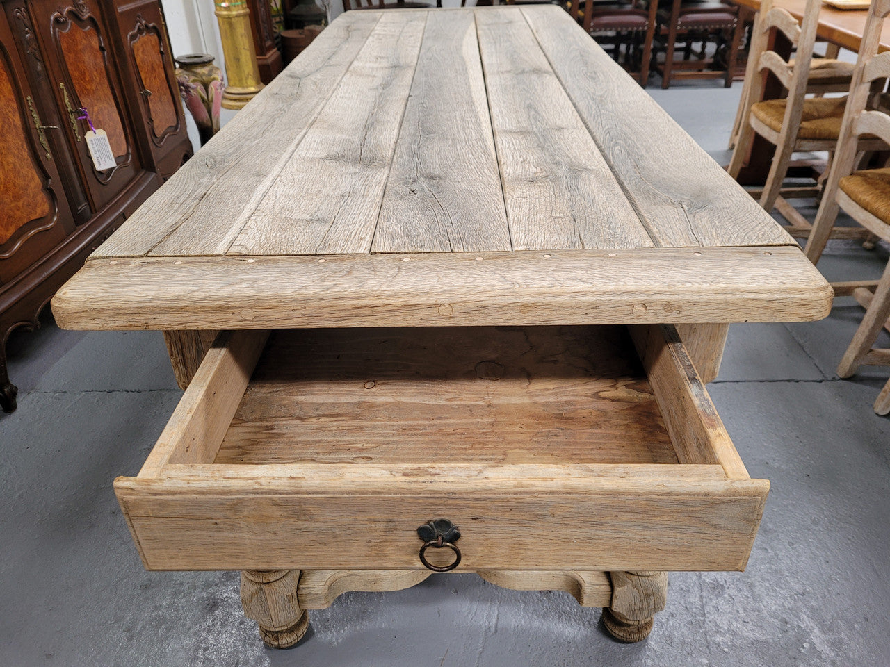 French stripped Oak pedestal stretcher base Farmhouse table with two drawers on either side of table. Features raw wood that could be used as is for a distressed look, or finished and waxed for a more refined look.