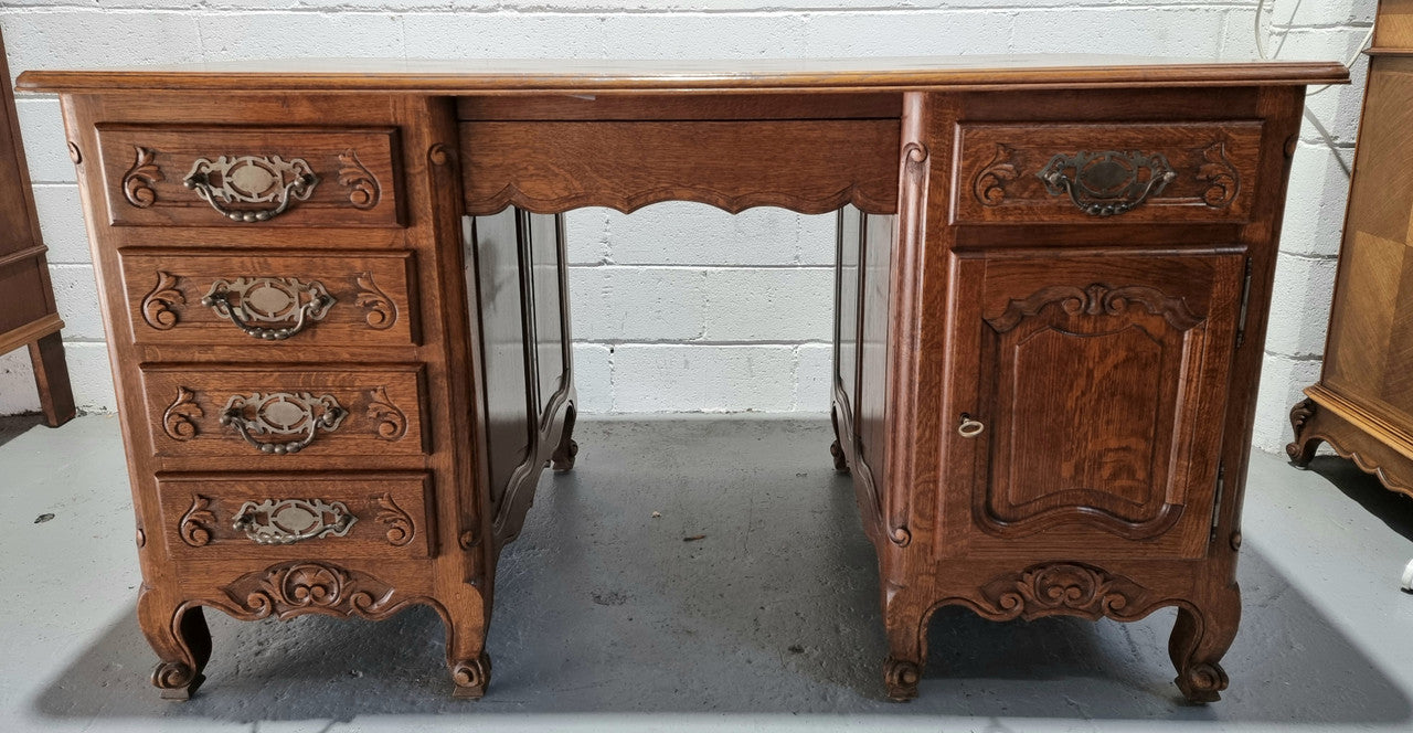 Beautifully carved french oak, faux partners desk with a lovely parquetry top and 6 drawers and 1 cupboard . In good original condition.