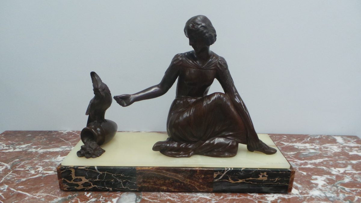 An Art Deco bronze statue with brown patina, of a lady and parrot on a marble base. Signed by Italian Sculptor A Trefoloni, an important and highly regarded sculptor. The statue is in very good condition.