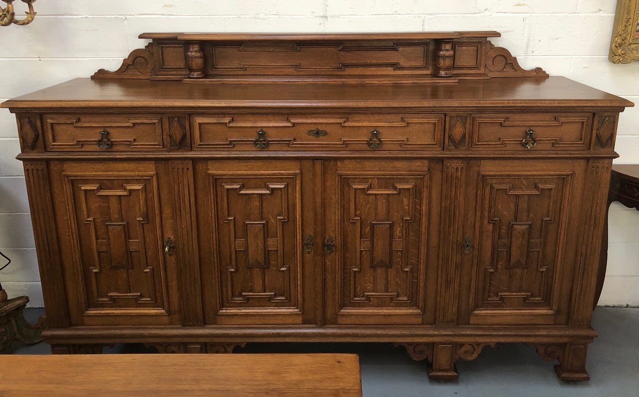 Beautiful carved French Oak four-door buffet with three drawers and lots of room for storage in good original detailed condition.
