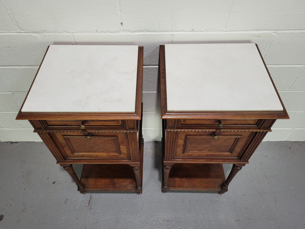 Pair parquetry Walnut bedside cabinets with white inset marble tops. In good original detailed condition.