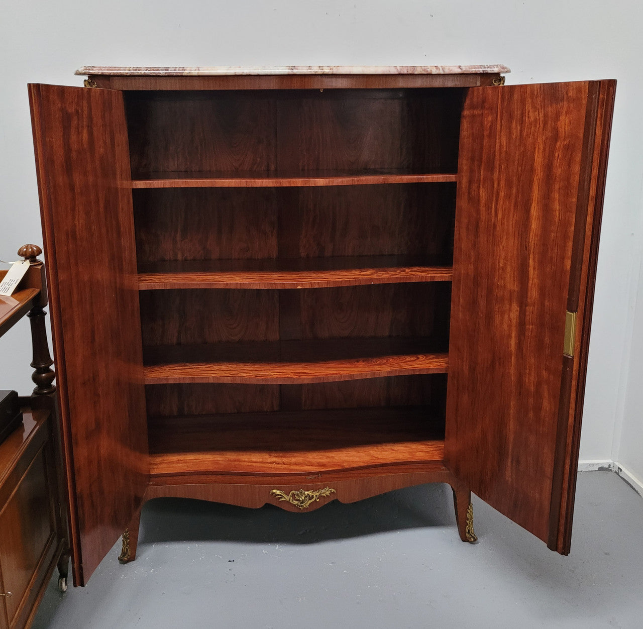 French Louis 15th style Kingwood marquetry inlaid two door cupboard with a beautiful marble top. It has three adjustable shelves and decorative ormolu trim. It has been sourced from France and is in good original detailed condition.